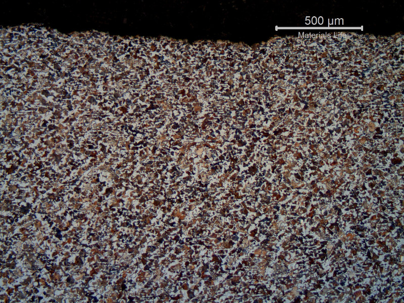 Micrography of the longitudinal section of the shaft, at the damaged surface (with a light wear).  In low magnification the ferritic perlitic texture reveals the forging lines.