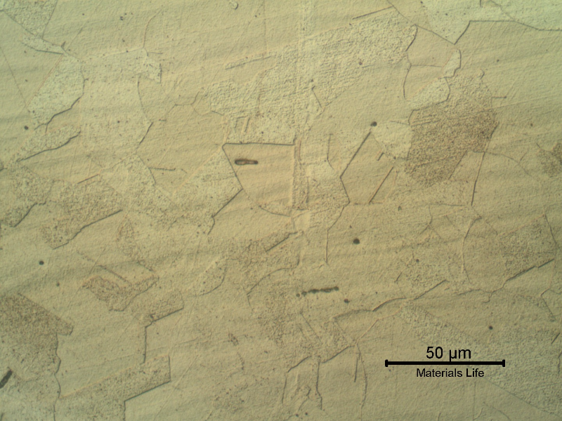 Elbow base metal micrographic detail presenting a granular microstructure. Like the pipe, the microstructure reveals inclusions.