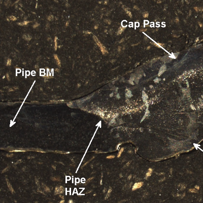 Macrography of the pipe to fitting welded joint, in a region where the thickness loss is almost uniform. The pipe is in the left of the figure and the elbow is in the right, with a general thinning (average of 2 mm, considering that the original thickness was 3.7 mm), and a slightly more intense thickness loss at the weld metal near the elbow side.
