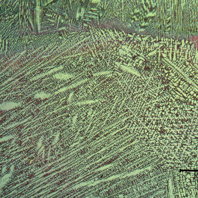 Micrography of the weld metal close to the center.  Celular and colunar dendritic structures are visible with a lower magnification. Chromic acid, electrolytic etched.