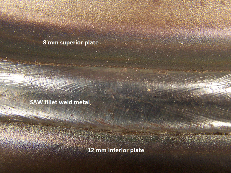 Aspect of the fillet weld between the superior plate (Low carbon 8 mm thick) and the inferior plate (C-Mn 12 mm thick), in an overlap geometry. In this region the welded joint was sound.