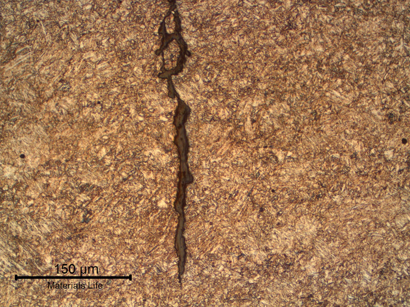 The micrography of one of the (multiple) cracks shows the slightly irregular morphology of the cracking, typical of a corrosion-fatigue mechanism.
