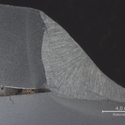 Macrography of the typical welded joint between the superior plate (8mm) and the inferior plate (12 mm) using one SAW fillet. The superior plate is welded in the thickness and the inferior plate is welded at the surface in this overlap joint. See the schematic drawing in the next figure