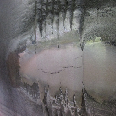 Aspect of the butt welded joint surface, after grinding to remove the reinforcement, polishing and macro etching.  There are multiple cracks, transverse to the weld and restricted to the weld metal.  The surface hardness are 167HB for the tube (left side), 180 HB for the Forged T (right side) and 272 HB for the weld metal, suggesting lack of a suitable PWHT.