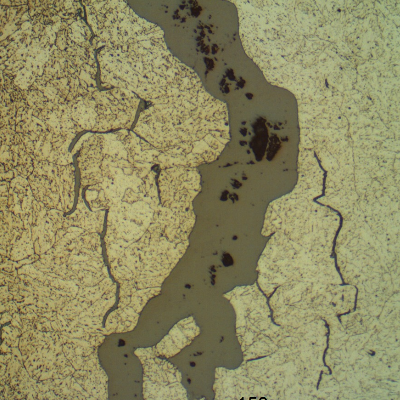 Micrographic aspect of opened cracks, filled with oxides.