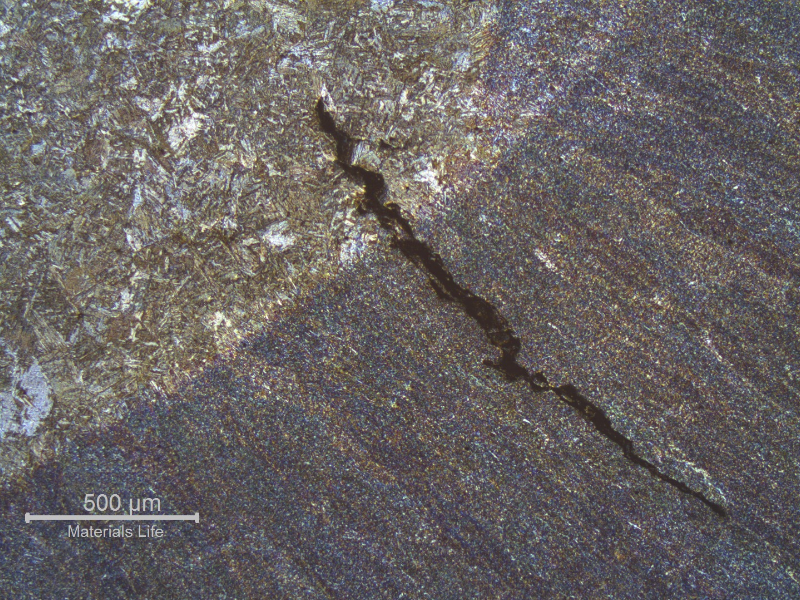 Micrography of the welded joint fusion line presenting the liquation cracking.  The weld metal is in the right side (bottom) and the forged connector heat affected zone is in the left side (top).