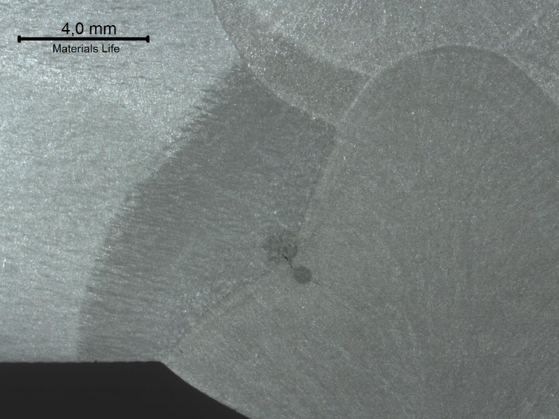 Hot cracking at the fusion line of the connector side, in a welded joint between a forging and a pipe, in a macrographic sample.  The region of the heat affected zone of the connector presents a dendritic aspect suggesting that the forging reduction rate of the connector was not too high and did not broke the cast structure.
