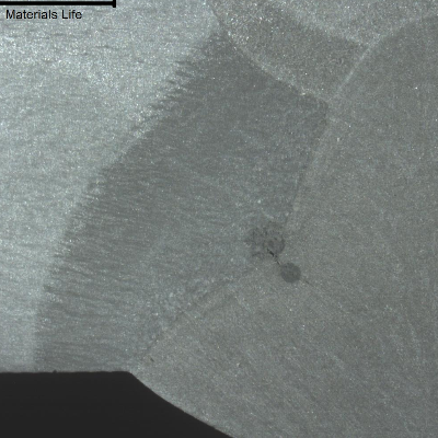 Hot cracking at the fusion line of the connector side, in a welded joint between a forging and a pipe, in a macrographic sample.  The region of the heat affected zone of the connector presents a dendritic aspect suggesting that the forging reduction rate of the connector was not too high and did not broke the cast structure.