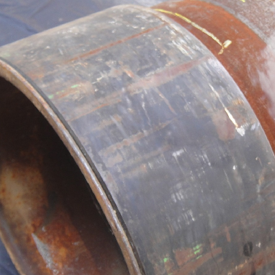 The connector was welded to the pipe from both (internal and external) sides, a PWHT was applied and the part was machined.  The UT indication was detected during final inspection.