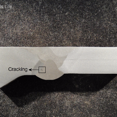 The macrography of a longitudinal section of the pipe and connector, at the welded joint, shows that the welding was conducted from both side of the groove, starting from the ID and finishing from the OD, ID later machined flush. The cracking was detected by ultrasonic test and the macro shows that it is at the fusion line, growthing into the weld metal. See the schematic drawing in the next figure