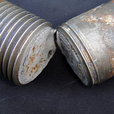 Aspect of the broken bolt 1 1/2" nominal diameter, after a short time in service (non residente subsea equipment) under cathodic protection. The bolt broke at the thread fillet, close to the head.