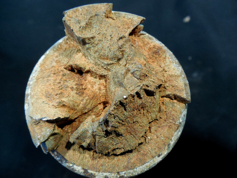 Aspect of the bolt fracture.  The fracture appearance is irregular.