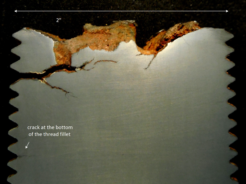 The longitudinal macrosection shows the fracture appearance, irregular, and a lot of secondary cracks transverse to the bolt axis, and longitudinal.