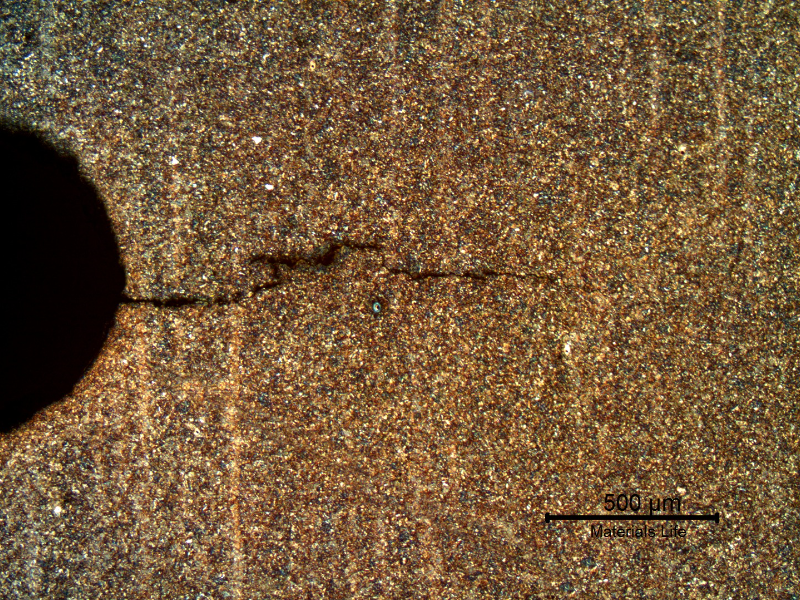 Micrography of a longitudinal section of the bolt, showing the (secondary) crack propagating, transverse to the bolt, from a thread fillet.