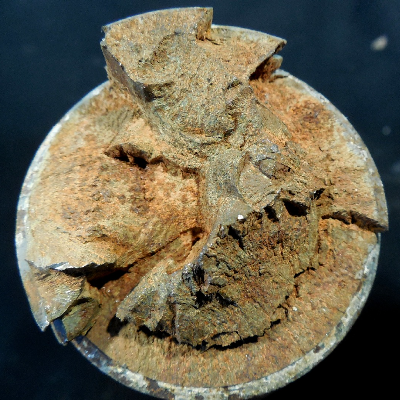 Aspect of the bolt fracture.  The fracture appearance is irregular.