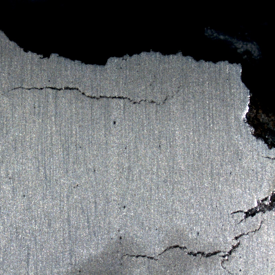 Several secondary cracks in the broken bolt, responsible for the irregular shape of the fracture, that presentes brittle cracks in the transverse and longitudinal directions.