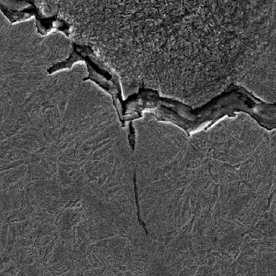 Micrographic detail of the intergranular secondary cracks, parallel to the fracture, typical of a hydrogen assisted cracking.  Close to the cracking it is possible to see an elongated inclusion, probably of a sulfide type.