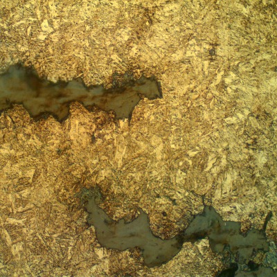 Micrographic detail of the intergranular secondary cracks, parallel to the fracture, typical of a hydrogen assisted cracking.
