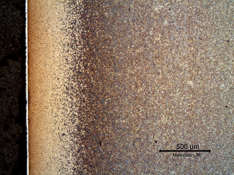 Micrography of a longitudinal section of the pin, at the surface. The pin was carburized, quenched and tempered (yellow diffuse layer at the surface, 0.5 mm of extension) and a white layer of hard chromium plating is evident.