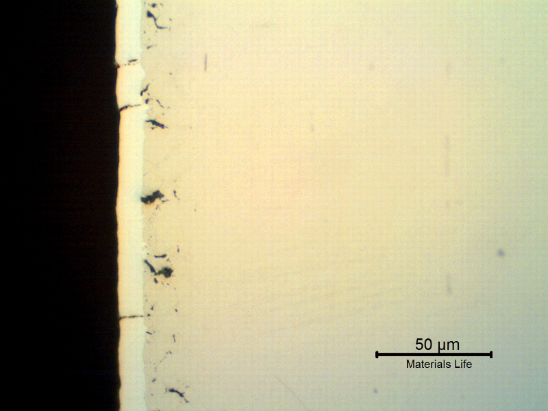 The as polished micrography of a longitudinal section of the pin, showing several microcracks associated to the chromium layer.