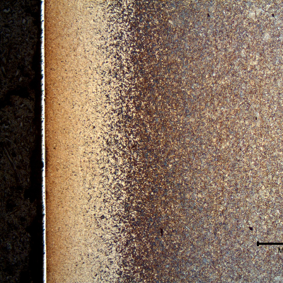 Micrography of a longitudinal section of the pin, at the surface. The pin was carburized, quenched and tempered (yellow diffuse layer at the surface, 0.5 mm of extension) and a white layer of hard chromium plating is evident.