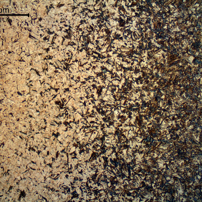 Micrographic detail a longitudinal section of the pin, at the surface, showing the case hardened.  The pin carburized, quenched and tempered structure presents a gradient of carbon content and consequently a gradient of martensitic structure and hardness.  Close to the surface the hardness level is 742 HV1 .