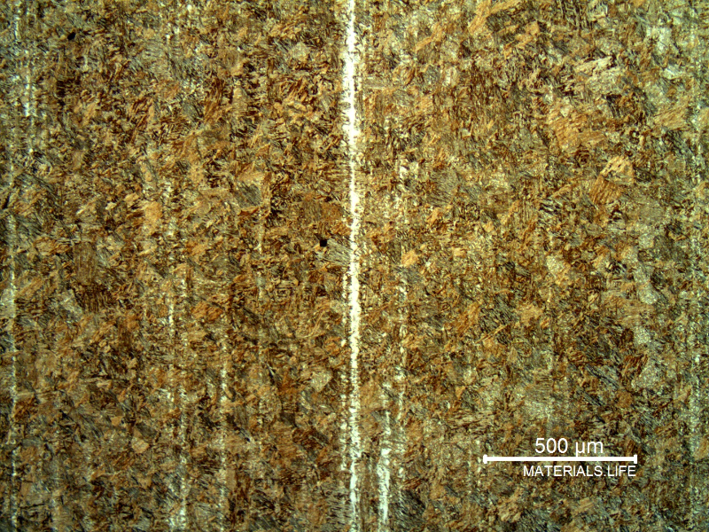 Micrography of the pin microstructure at the longitudinal section showing a tempered martensitic structure and a band of retained austenite.