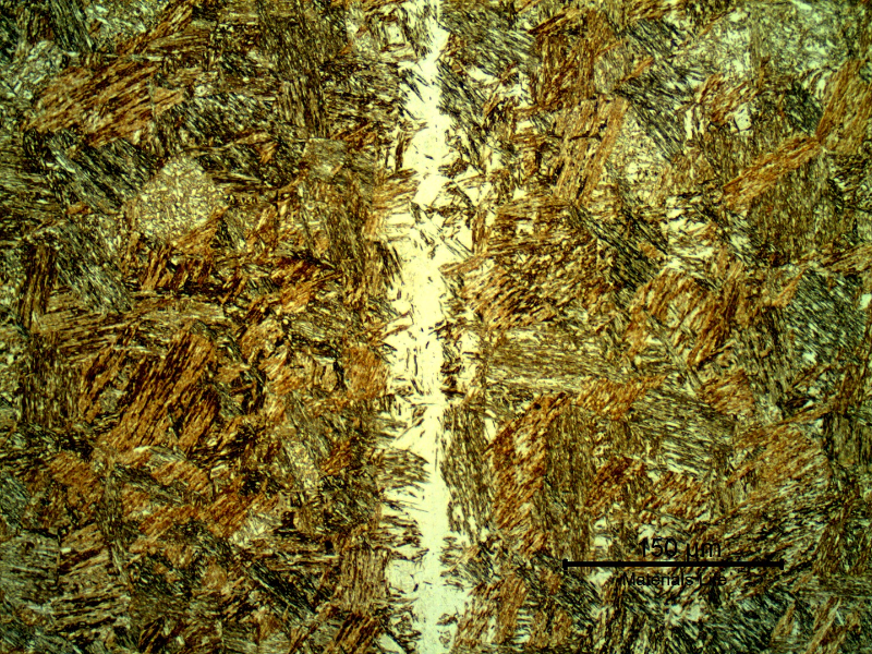 Micrographic detail of the pin microstructure at the longitudinal section showing a tempered martensitic structure and a band of retained austenite.