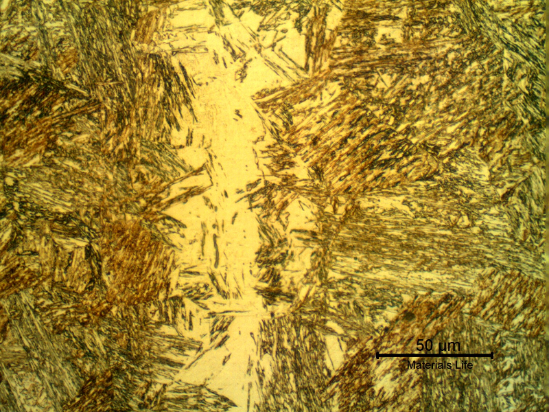 Micrographic detail of the pin microstructure at the longitudinal section showing a band of retained austenite in martensitic structure.
