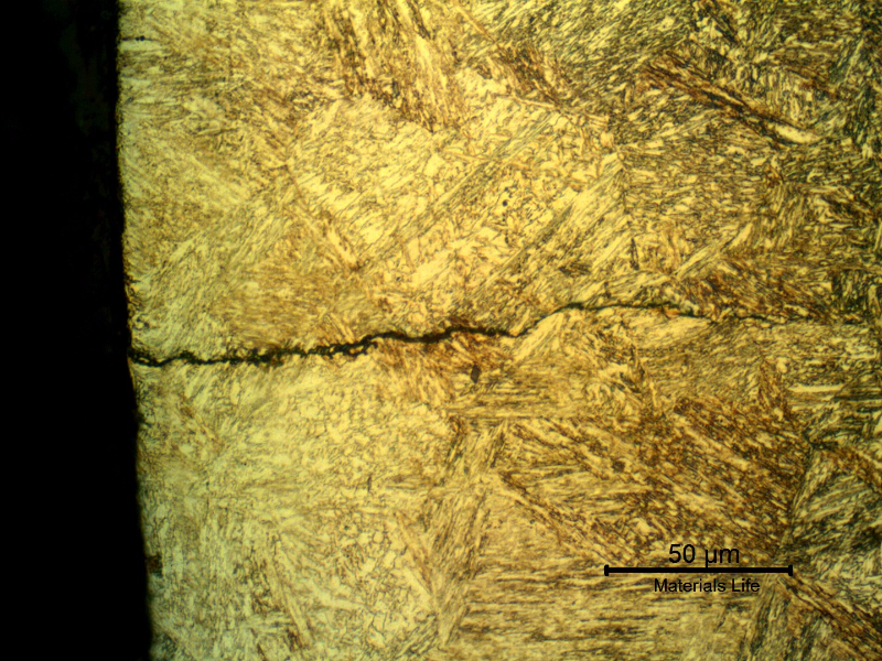 Micrographic detail of a secondary cracking close to the fracture position. The crack presents no plastic deformation, is slightly branched and filled with products.