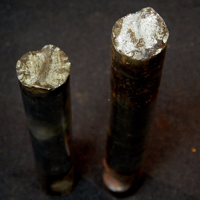 Aspect of the 5/8" diameter pin, that was 3" long and broke close to the center.