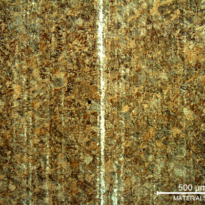 Micrography of the pin microstructure at the longitudinal section showing a tempered martensitic structure and a band of retained austenite.