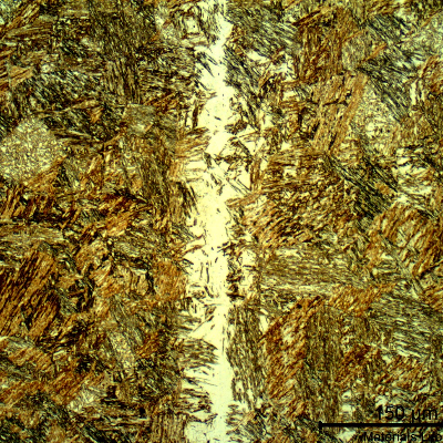 Micrographic detail of the pin microstructure at the longitudinal section showing a tempered martensitic structure and a band of retained austenite.