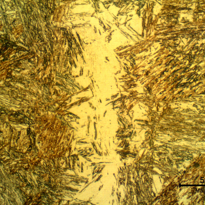 Micrographic detail of the pin microstructure at the longitudinal section showing a band of retained austenite in martensitic structure.