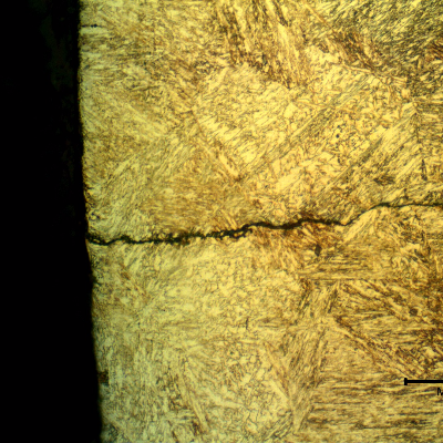 Micrographic detail of a secondary cracking close to the fracture position. The crack presents no plastic deformation, is slightly branched and filled with products.