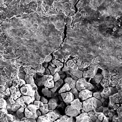 The scanning electron microscopy image of the internal surface of the tube in position 2 shows a localized  corrosion region with intergranular morphology, as well a crack from the corroded region.
