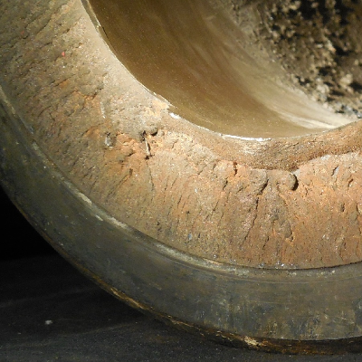 Visual aspect of the tool joint (TJ) that fractured in the pin body when it was assembled (the box appears as a sleeve in the pin OD).  The internal coating is not damaged. The fracture is flat and presents little evidences of plastic deformation, indicating that the pin broke in a brittle way.