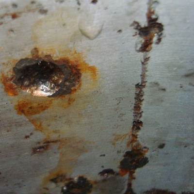 Deep localized corrosion spots, rusted. There are indications that the roughness of the surface influences the localized corrosion location.