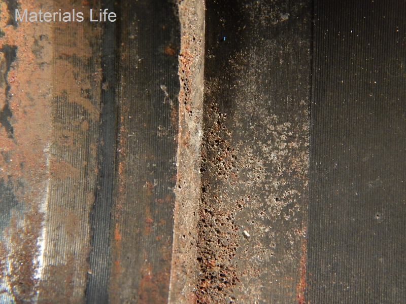The aspect of the internal side of the housing showing pitting corrosion.