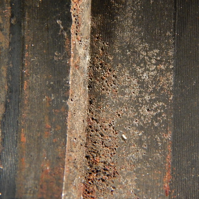 The aspect of the internal side of the housing showing pitting corrosion.