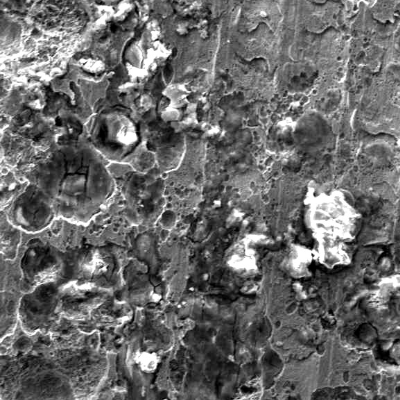 Details of the pitting corrosion at the internal surface. There are cracks inside some pits.