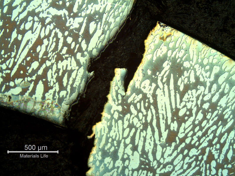 Micrography of a transverse section of the fitting, at the cracking position.  Note the through wall cracking at the coarse austenitic ferritic structure.