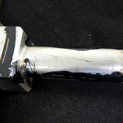 Aspect of the fitting welded to a tubing, ND 5/8" in a hydraulic line. The through wall cracking is longitudinal in the fitting side.