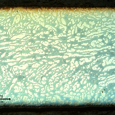 Micrography of the fitting longitudinal section, showing a coarse austenitic ferritic structure.