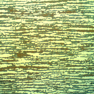 Micrographic detail of the tubing longitudinal section showing a refined austenitic ferritic structure.