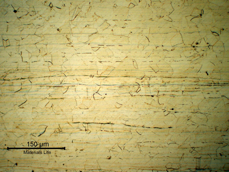 Base metal micrography in the longitudinal section, showing an austenitic granular structure. Ghost lines evidence the hot forming direction.