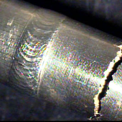 Detail of the welded joint between the 316 tubing (left side) and the nitronic fitting (right side). The through wall cracking is transverse to the line, in the fitting, 10 mm far from the weld, where the fitting was slightly bent to be assembled (cold bent).
