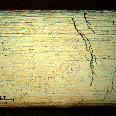 Micrography of the longitudinal section of the hydraulic line sample at the cracking position, localized in the fitting and starting from the outer diameter (OD).