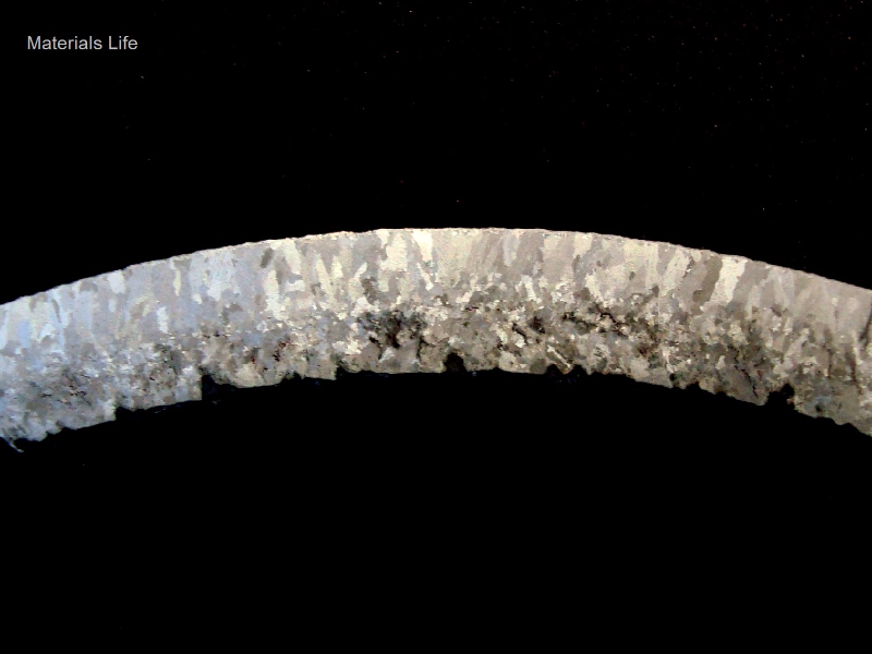 The macrography of a transverse section of the tube removed from service after 6 months, with damage  close to the internal tube surface.  The tube is a 4" diameter and 1/4" thick.