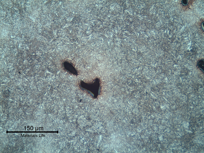 Micrography of the lifting padeye showing a quenched and tempered martensitic microstructure. Voids are located in interdendritic segregated regions.
